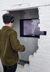 A chap watching Photo Score I, a 15-minute AV piece