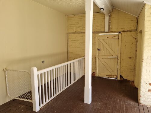 It looks like there's a cellar. Note also the beam ending directly above the door, with lots of cracks in the brickwork.